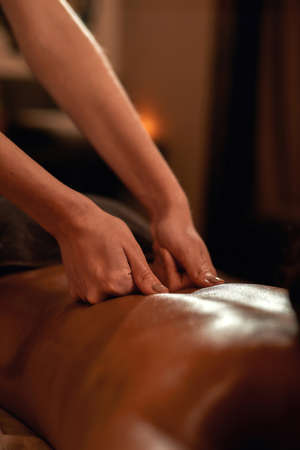 Masseur do massage of african woman in spa salonの写真素材