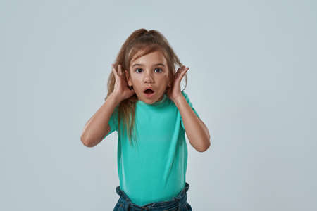 Surprised girl with open mouth looking at camera