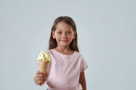 Front view of girl holding sweet ice cream cone