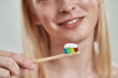 Selective focus of toothpaste on toothbrush in guyの写真素材