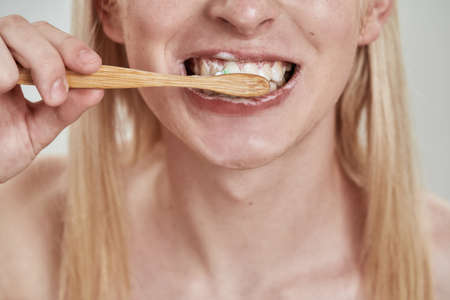 Close up of guy brushing teeth with toothpasteの写真素材