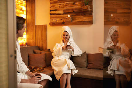 Young caucasian couple drinking tea in spa salonの写真素材