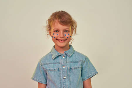 Little girl with blue flower rhinestones on face