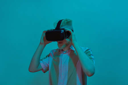 Albino guy putting on head Virtual reality glasses