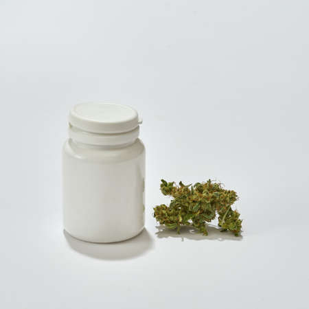 Green marijuana weed and jar on white backgroundの写真素材