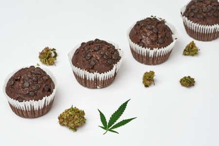 Cupcakes in row with green marijuana leaf and budsの写真素材