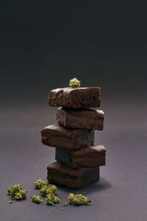 Stack of chocolate cake pieces and marijuana budsの写真素材