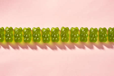 Collection of green sweet delicious candies in rowの写真素材