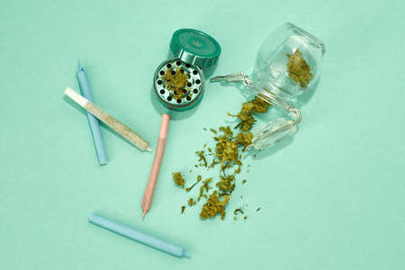 Jars with crushed marijuana buds and rolled jointの写真素材