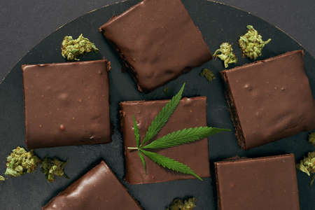Chocolate cake and green marijuana leaf and budsの写真素材