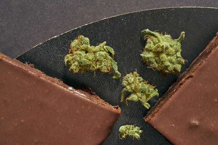 Sweet cake pieces and dry crushed marijuana budsの写真素材