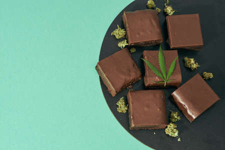 Plate with chocolate cake pieces and marijuanaの写真素材
