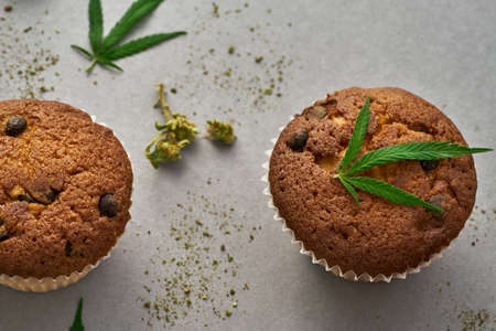 Partial of sweet cupcakes with green marijuanaの写真素材