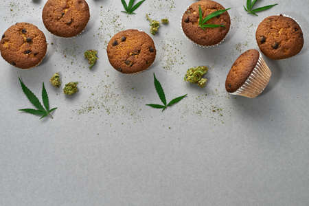 Sweet cupcakes with marijuana leaf and dry budsの写真素材