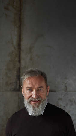 Portrait of elderly caucasian man look at camera