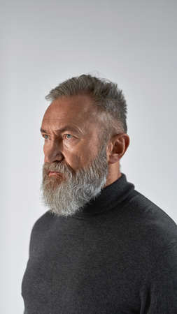 Trendy elderly focused caucasian man looking away