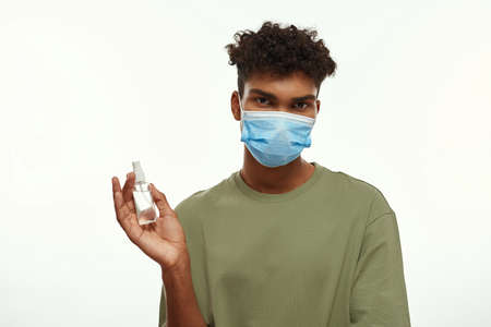Black guy wear medical mask hold sanitizer in hand