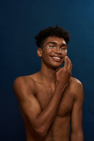 Cropped of smiling guy correct under eye patchの写真素材