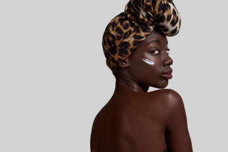 Partial back of black girl with cream on faceの写真素材
