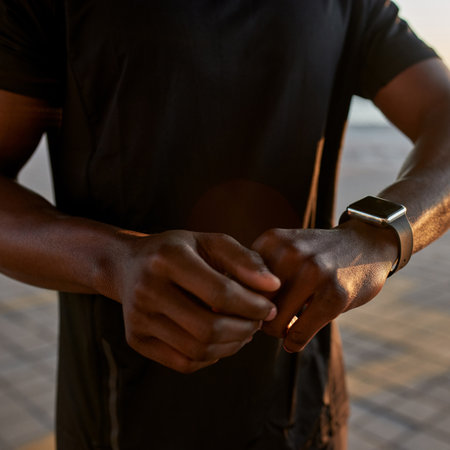 Partial of african sports man using smartwatchの写真素材