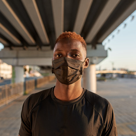 Portrait of black sportsman wearing medical maskの写真素材