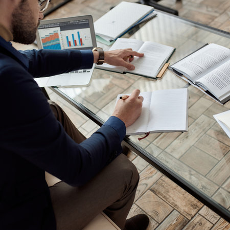 IT seller or entrepreneur writing notes from book