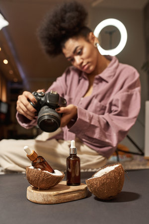 Girl take photo of oil bottles and coconut slicesの写真素材