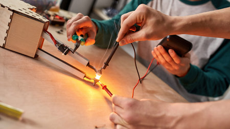 Engineers do experiment with forceps and voltmeterの写真素材