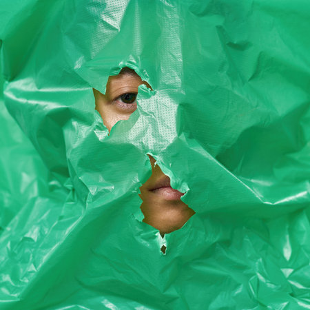 Human mouth and eye looking through plastic bag