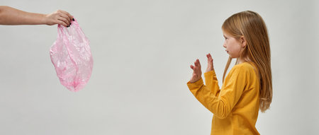 Dissatisfied girl show no to hand give bag to herの写真素材