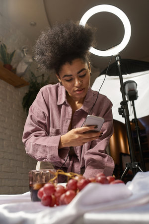 Girl take photo of cola drink and grapes on phone