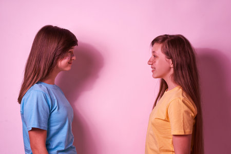 Side view of teenage girls looking at each otherの写真素材