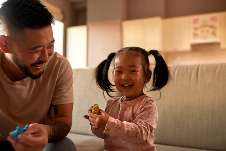 Laughing dad and daughter sculpt with plasticineの写真素材
