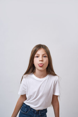 Little girl stick out tongue and look at cameraの写真素材