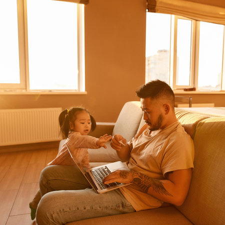 Girl pull hand to father with digital thermometerの写真素材