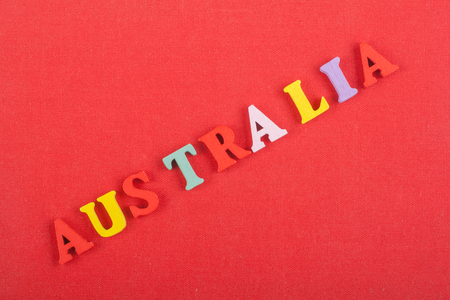 AUSTRALIA word on red background composed from colorful abc alphabet block wooden letters, copy space for ad text. Learning english concept.の写真素材