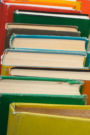 Book stacking. Open hardback books on wooden table and blue background. Back to school. Copy space for ad textの写真素材
