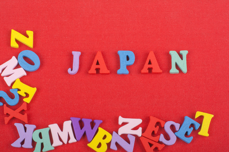JAPANESE word on red background composed from colorful abc alphabet block wooden letters, copy space for ad text. Learning english concept.の写真素材