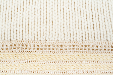 Sweater or scarf fabric texture large knitting. Knitted jersey background with a relief pattern....