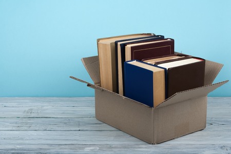 Open books on on wooden deck table and blue background. Back to School. Education concept with copy space for your ad text.の写真素材