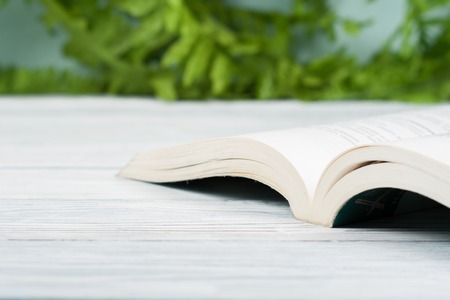 Open hardback book, on wooden table. natural background . Back to school. Copy space for text.の写真素材