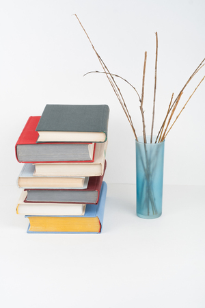 Book stacking. Open book, hardback books on wooden table and white background. Back to school. Copy space for textの写真素材