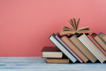 Stack of colorful books. Education background. Back to school. Book, hardback colorful books on wooden table. Education business concept. Copy space for text.の写真素材