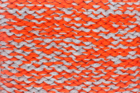 Sweater or scarf fabric texture large knitting. Knitted jersey background with a relief pattern....