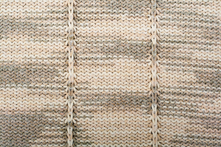 Sweater or scarf fabric texture large knitting. Knitted jersey background with a relief pattern. Wool hand- machine, handmade.の写真素材