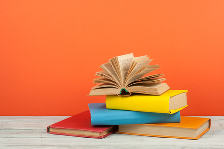 Open book, hardback colorful books on wooden table. Back to school. Copy space for text. Education business concept.の写真素材