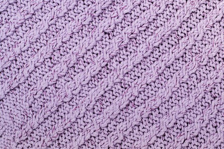 Sweater or scarf fabric texture large knitting. Knitted jersey background with a relief pattern....