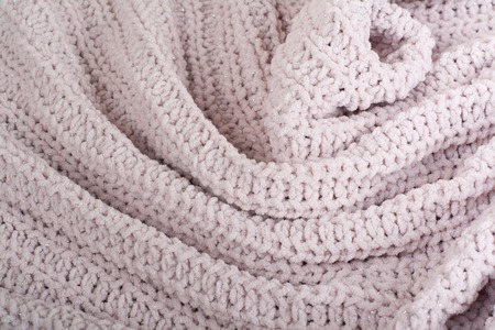 Sweater or scarf fabric texture large knitting. Knitted jersey background with a relief pattern. Wool hand- machine, handmade.の写真素材