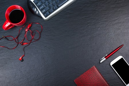 Black Office desk table with computer, pen and a cup of coffee, lot of things. Top view with copy space.の写真素材