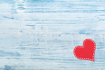 Red paper hearts on a wooden background. Valentines Day. Copy space. Top view.